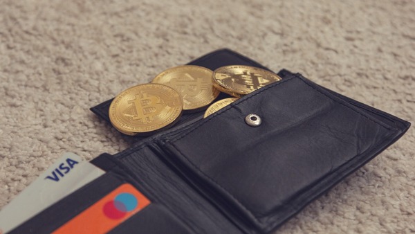 Leather wallet with bank cards and gold crypto coins