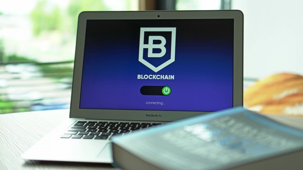 Laptop showing a blockchain app on a desk