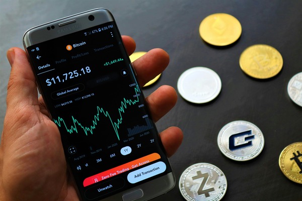 Smartphone crypto wallet app surrounded by coins