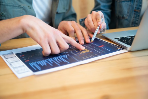 Hands pointing at a crypto chart on a tablet