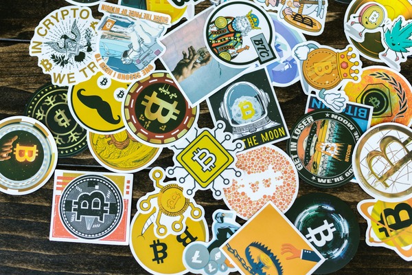 Colourful crypto stickers spread on a table