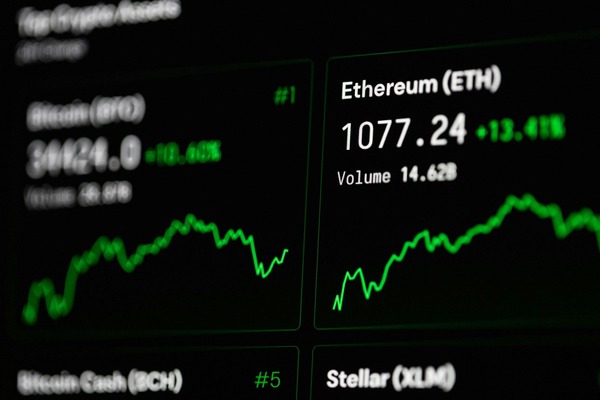 Crypto price tickers with green charts on a dark screen