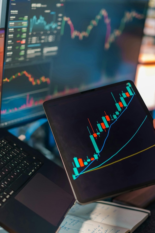 Tablet with a rising crypto chart on a desk