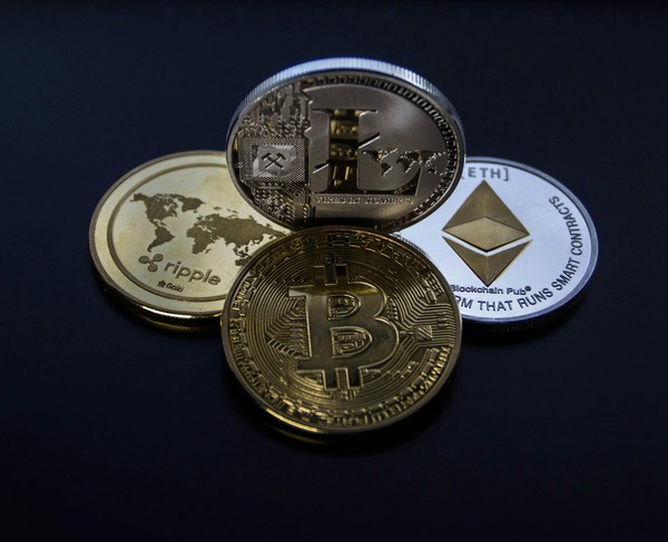 Bitcoin, Ethereum and Ripple coins arranged on a navy background